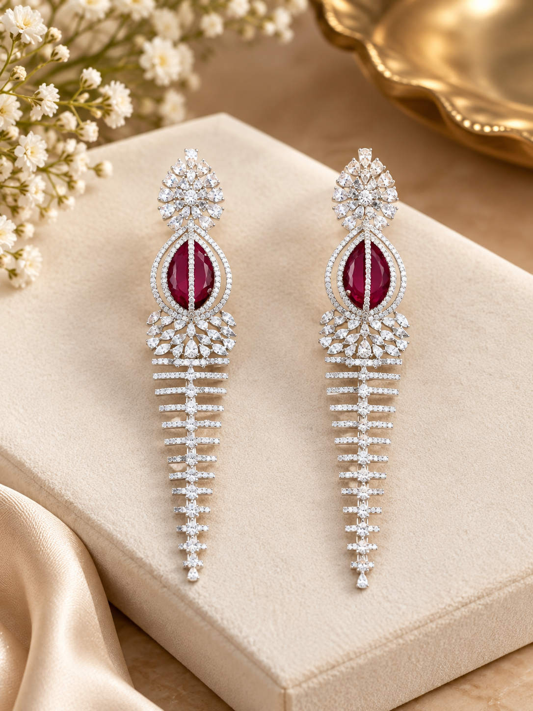 Elegant Rhodium-Plated Cascading Chandelier Earrings with Ruby-Red Centerpiece.