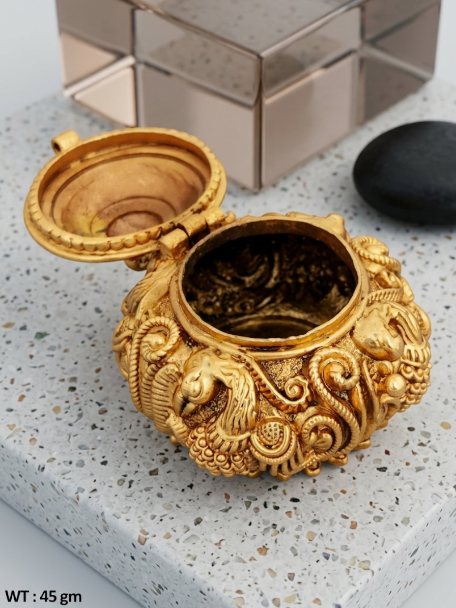 Rihum Jewels handcrafted gold-plated kumkum box with intricate peacock Nakshi engravings and a hinged lid.